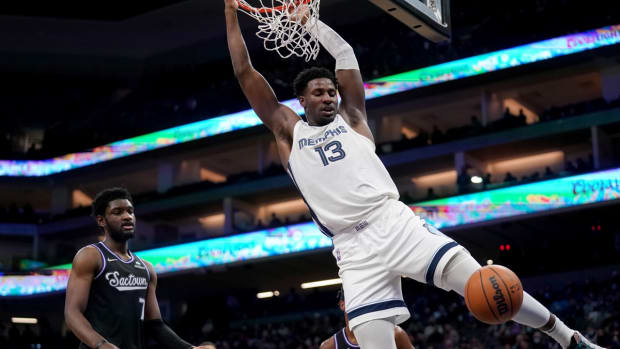 Dec 17, 2021; Sacramento, California, USA; Memphis Grizzlies forward Jaren Jackson Jr. (13) dunks the ball in front of Sacramento Kings forward Chimezie Metu (7) in the fourth quarter at the Golden 1 Center. Mandatory Credit: Cary Edmondson-USA TODAY Sports